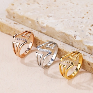 Three multi-layered rose gold, silver, and gold rings with V-shape and crystals