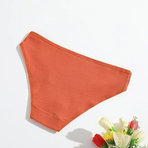 Detailed view of orange ribbed cotton panties for women with breathable dual-layer crotch