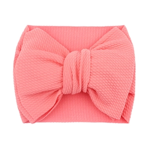 Soft pink elastic baby headband featuring a large textured bow for infants on white background