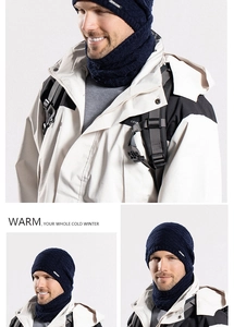 Close-up of dark blue winter knit beanie and matching neck gaiter with woven logo
