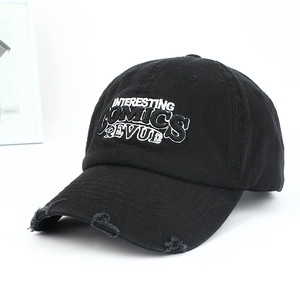 Detailed view of American vintage black distressed baseball cap with white embroidery lettering