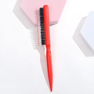Detailed macro view of the professional red hair styling brush with mixed nylon and boar bristles