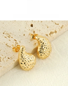 Detailed view of 18K gold plated hammered texture waterdrop earrings on stone