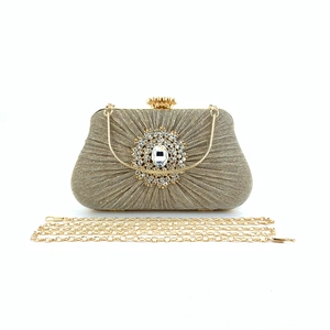 Elegant pleated champagne gold evening clutch with crystal ornament and chain strap