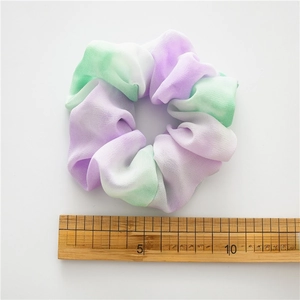 Chiffon tie-dye hair scrunchie in purple and mint green with 10cm size reference
