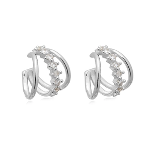 Close-up of silver layered ear cuffs with shimmering zircon pavé and metallic finish