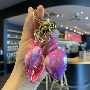 Iridescent conch keychain with gold bell and ring for women handbags and car accessories