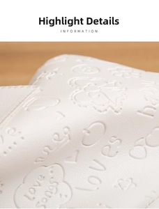Close-up of white embossed leather with lychee texture and heart pattern details