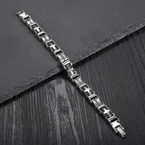 Classic stainless steel chain bracelet with cross pattern links on a dark textured background
