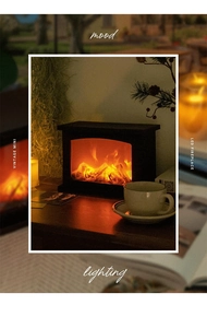 Close-up of retro mini LED fireplace lamp with realistic flickering flame on wood desk