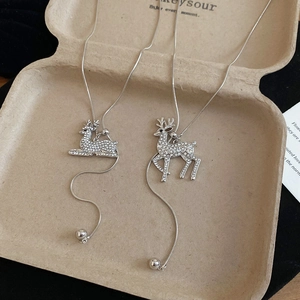 Detailed view of silver snake chains featuring shimmering rhinestone-encrusted deer pendants
