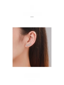 Close-up of minimalist S925 silver ear crawler featuring a curved five-stone zircon gradient