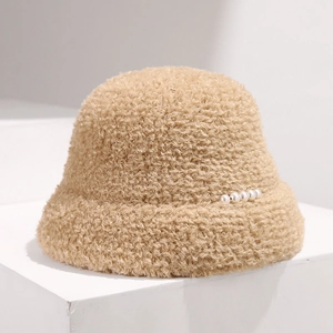 Detail of warm lamb wool bucket hat in beige with elegant pearl decorations
