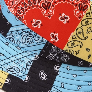 Close-up of paisley patchwork fabric showing red and blue patterns with fine stitching