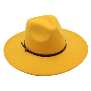 Detailed macro view of the wool fedora's yellow texture and black leather belt buckle