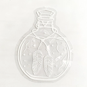 Macro detail of magic bottle static window cling with white embossed feather pattern