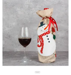 Detail of Christmas burlap wine bottle cover featuring an embroidered snowman with a red ribbon