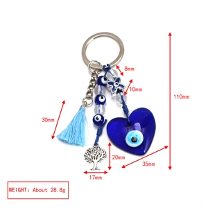 Detailed view of Evil Eye keychain with blue tassel and tree of life charm 110mm