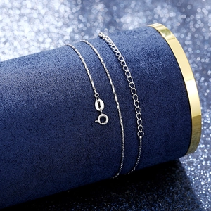 Detailed macro view of S925 sterling silver spring clasp and chain on blue velvet