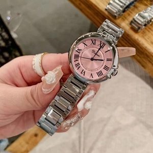 Detailed shot of a silver steel strap watch with pink Roman numeral dial on a model