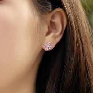 Elegant S925 sterling silver four-leaf clover earrings with pink gemstones on model