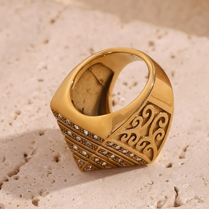 Macro shot of 18K gold plated ring featuring pyramid shape and hollow scrollwork detailing