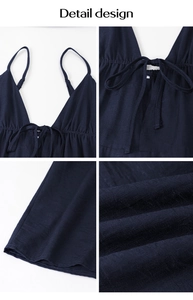 Detail design of dark blue V-neck jumpsuit showing lace-up chest and elastic waist fabric