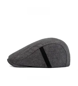 Detail view of dark grey flat cap side showing woven texture and metallic air vents