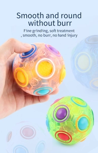 Detail of smooth rainbow magic ball puzzle toy with colorful pushable small spheres