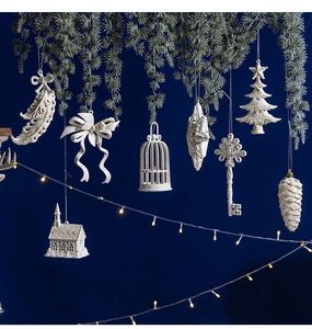 Close-up of cream white feather and birdcage Christmas tree ornaments with matte texture