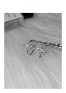 Close-up of silver star earrings with sparkling cubic zirconia on white fur background
