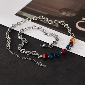 Detail showing stainless steel chain with colorful geometric beads and lobster clasp