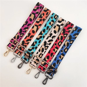Detail of adjustable colorful leopard print bag straps with metal hardware hooks