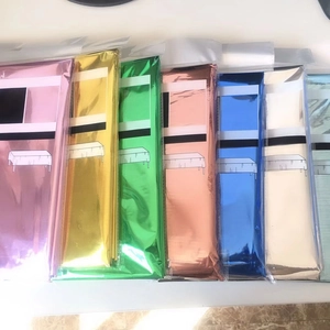 Macro view of multi-color metallic foil table skirts in individual retail packaging
