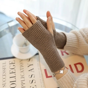 Detailed view of brown ribbed knit fingerless gloves for women in a warm winter setting