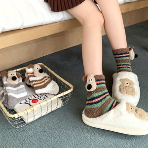 Detail of cute striped coral fleece socks with 3D puppy and plush bear indoor slippers
