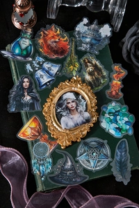 Detail of dark fantasy magic stickers with fox and potion motifs on a vintage book