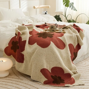 Nordic knitted blanket with red floral pattern on cream base for bed or sofa decor