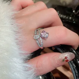 Elegant adjustable silver ring with square pink zircon and pear-cut crystal on finger