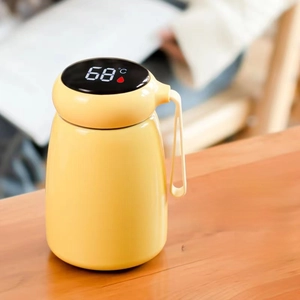 Detail of smart yellow mushroom thermos with LED temperature display and soft carrying strap