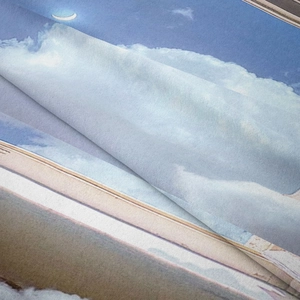Detail shot of soft brushed fabric texture showing moon and white cloud printing