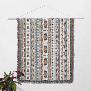 Detail of bohemian woven tapestry with sun pattern, geometric motifs and fringe decor