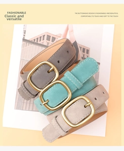 Detail of vintage suede belts in three colors with contrast stitching and bronze buckles