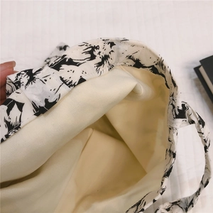 Detail view of cotton tote bag interior with thick canvas lining and floral pattern