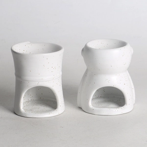 Detail view of abstract white speckled ceramic oil burners for aromatherapy home decor