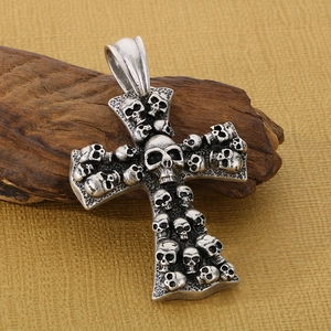 Vintage silver skull cross pendant in gothic style for men on rustic wood background