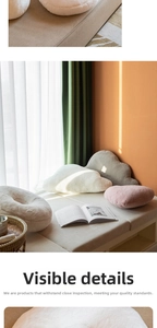 Close-up of fluffy faux rabbit fur pillows in cloud and donut shapes for cozy home decor