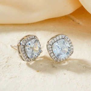 Detail of square halo stud earrings with micro-paved cubic zirconia in 4-prong setting