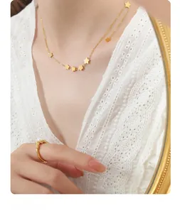 Detailed view of a gold star tassel necklace and pearl ring paired with white lace