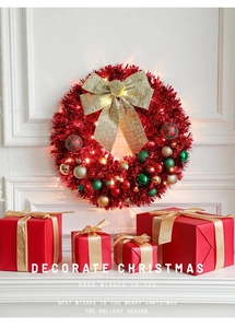 Close-up of 45cm Christmas wreath with red glitter, gold bow, and warm LED lights
